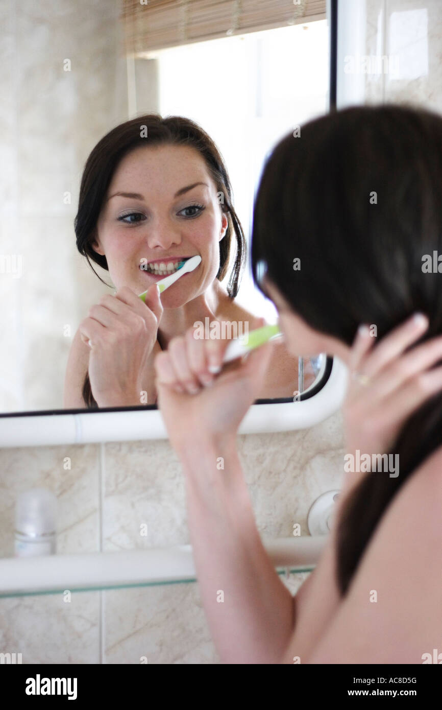 young woman brushing teeth Stock Photo
