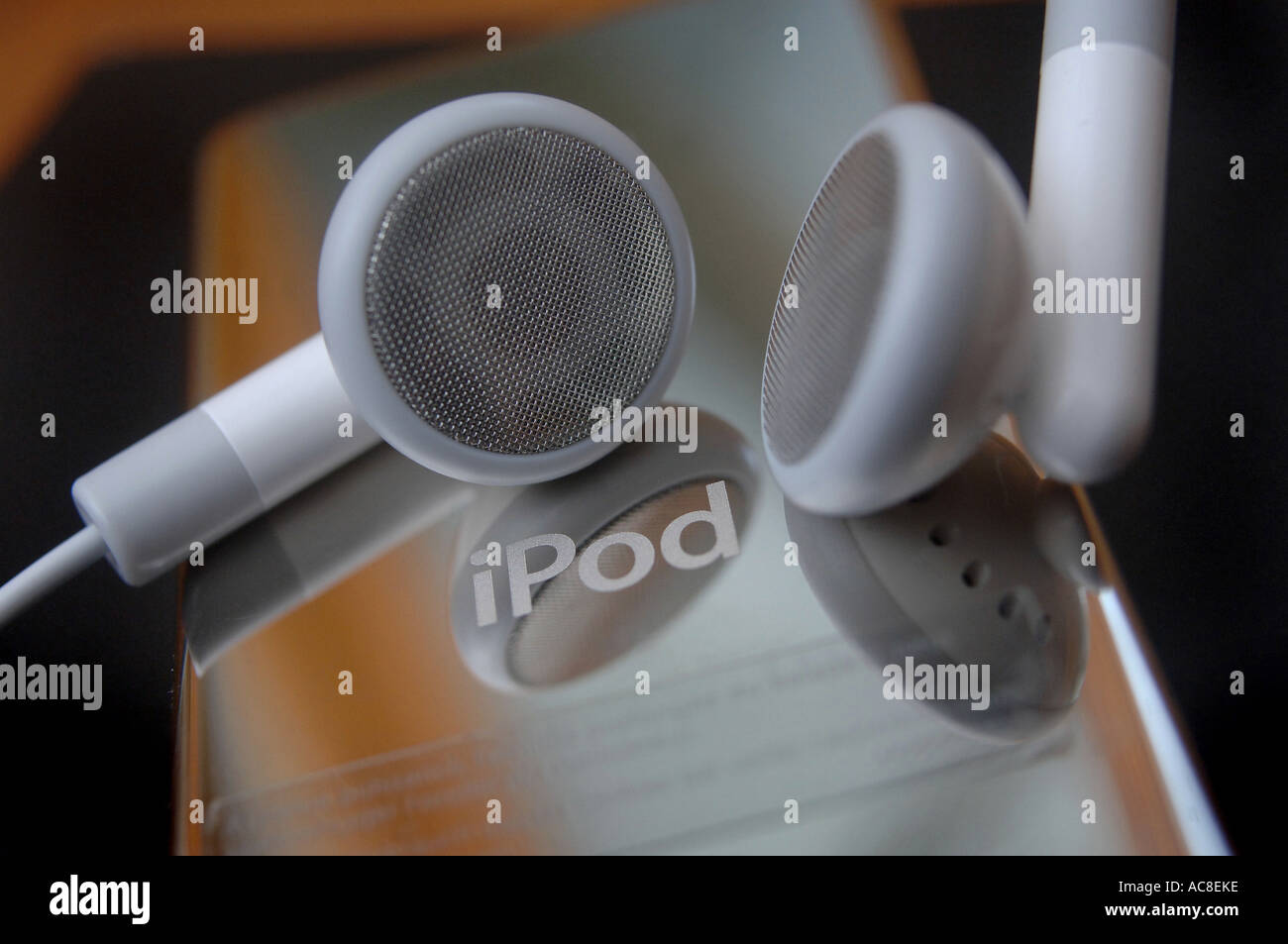 The back of an apple iPod nano showing the apple logo, with the headphones Stock Photo