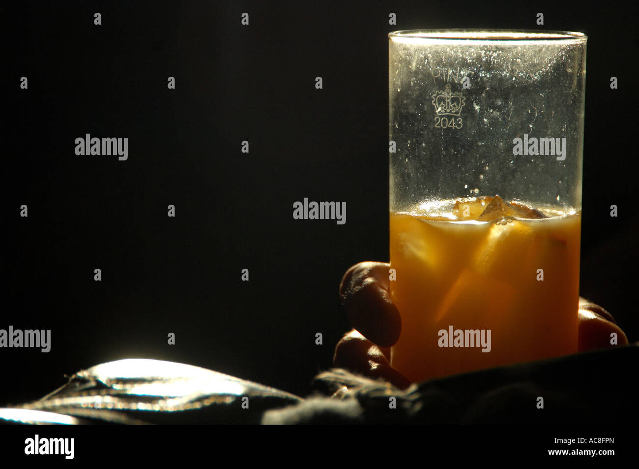 Man drinking glass of orange juice Stock Photo