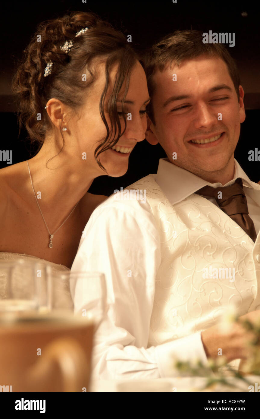 Bride and Groom laughing at the speeches at their wedding Stock Photo