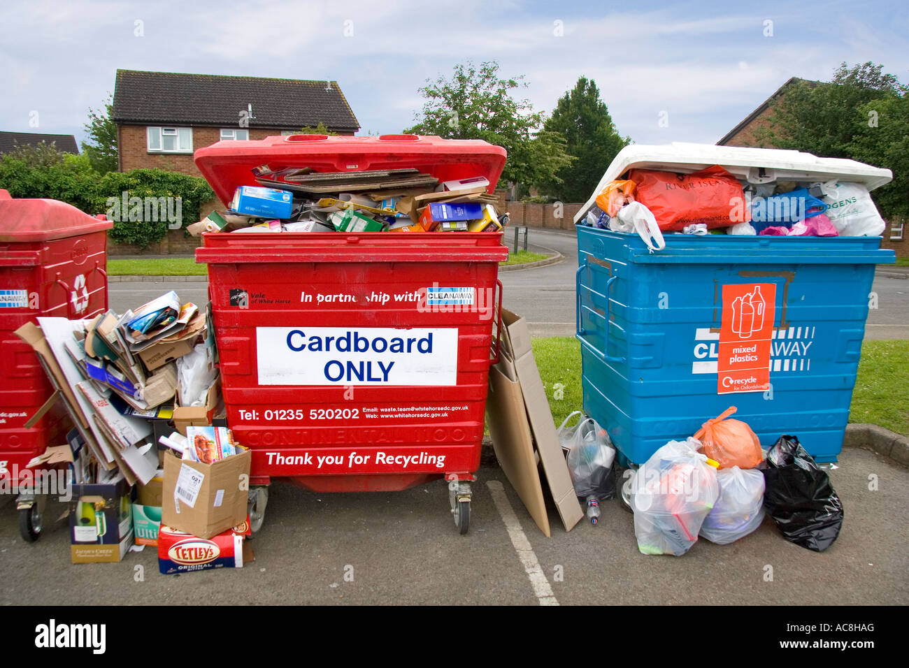Overflowing waste recycling point in Oxfordshire housing estate 8 Stock Photo