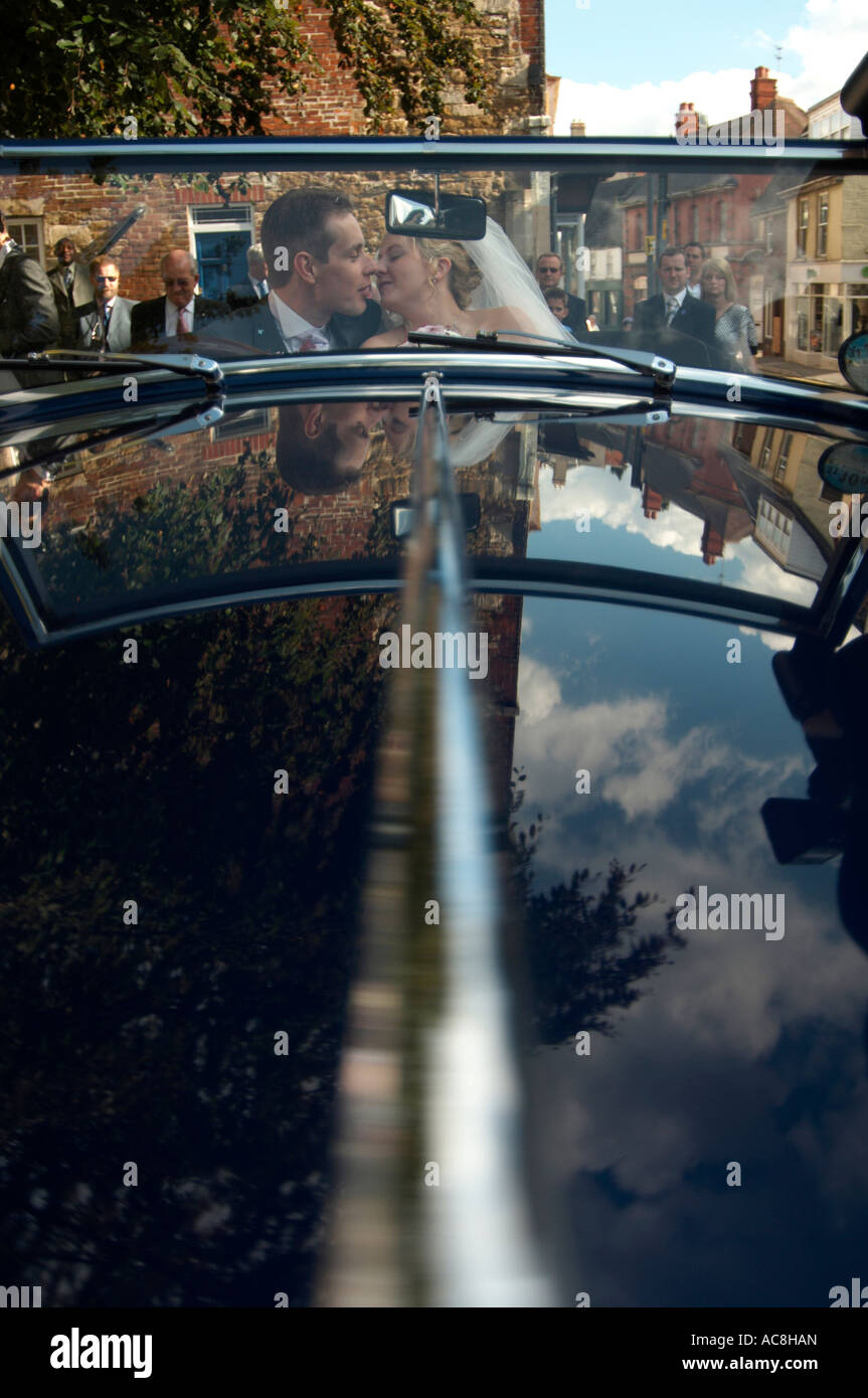 Bride and groom kissing in a car on their wedding day Stock Photo - Alamy