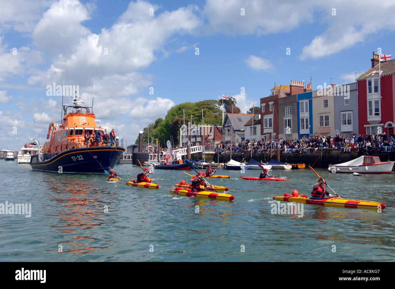 Canoeists pull Weymouth Lifeboat, Weymouth, Dorset Britain UK Stock Photo
