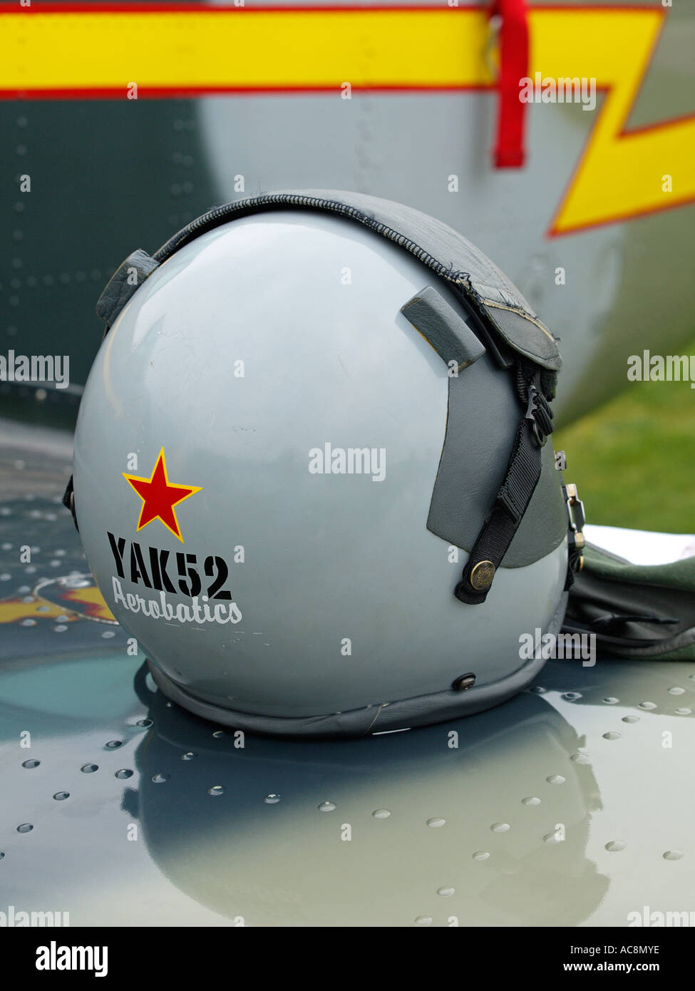Yakovlev Yak 52 aerobatics pilots helmet sitting on Yak 52 wing Stock Photo