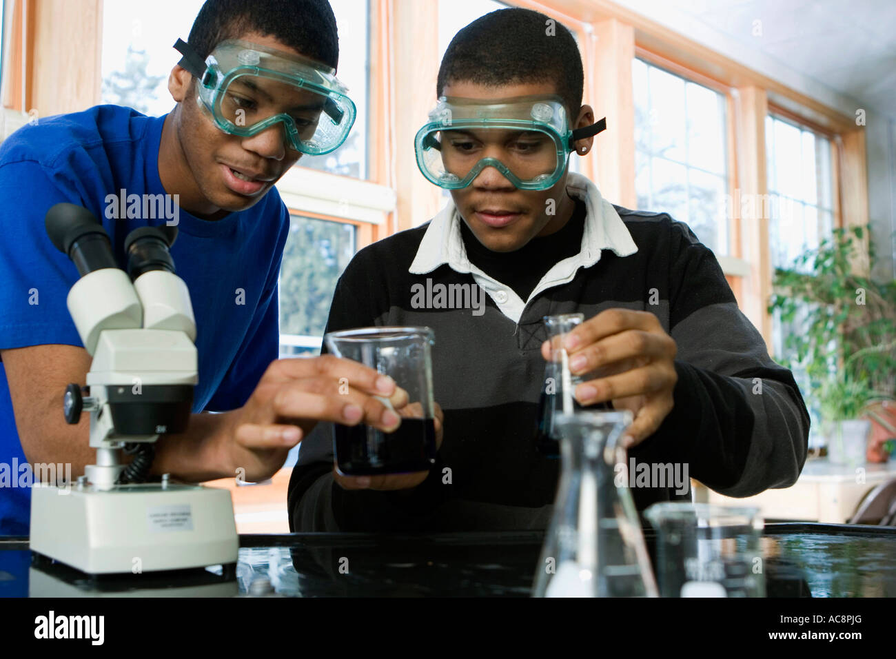 Student performing experiment in school hi-res stock photography and ...