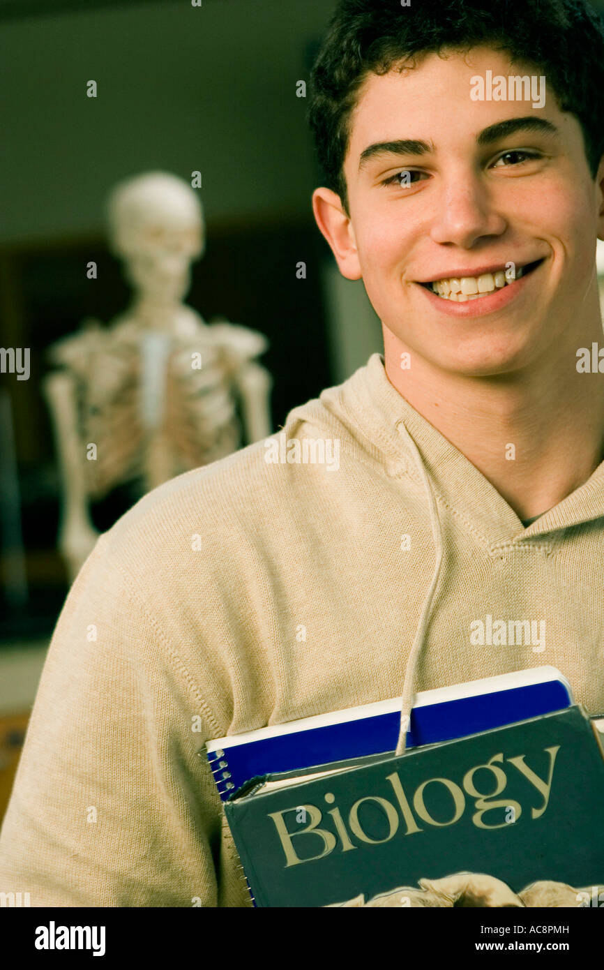 Portrait of a student holding books Stock Photo - Alamy