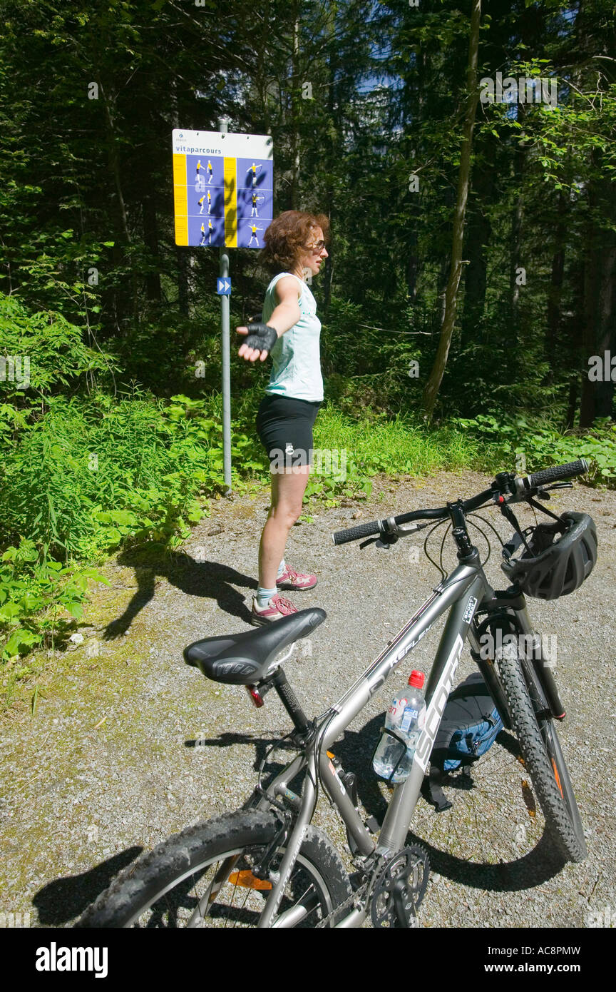 A women on an exercise trail in the frest near Flims, Switzerland Stock Photo