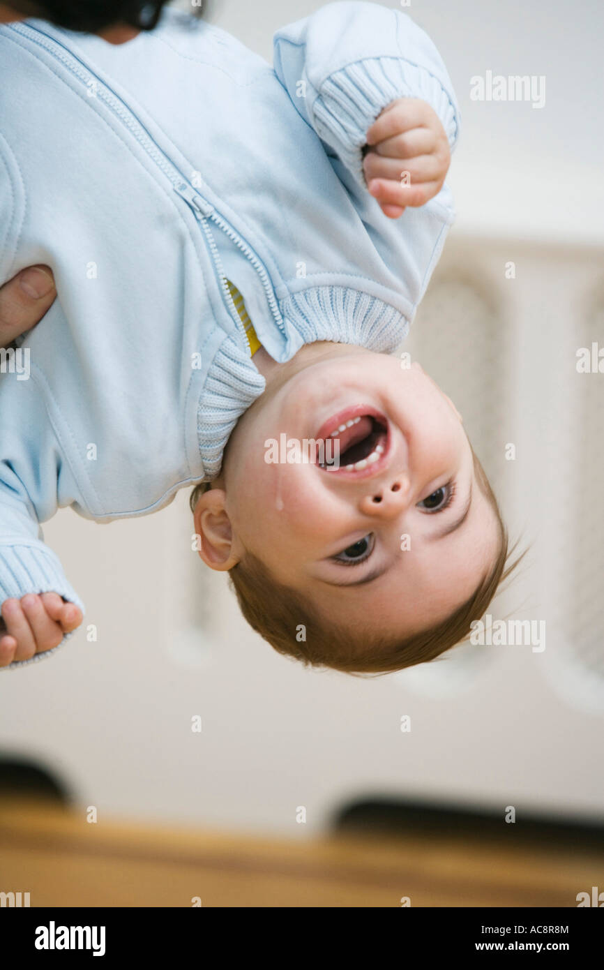 Baby boy hanging upside down Stock Photo Alamy