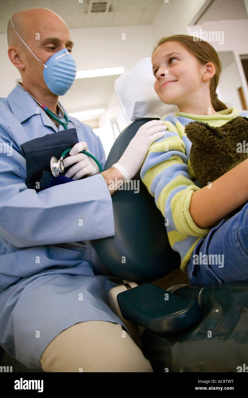 Low angle view of a male doctor with his hands on a patient's shoulder Stock Photo