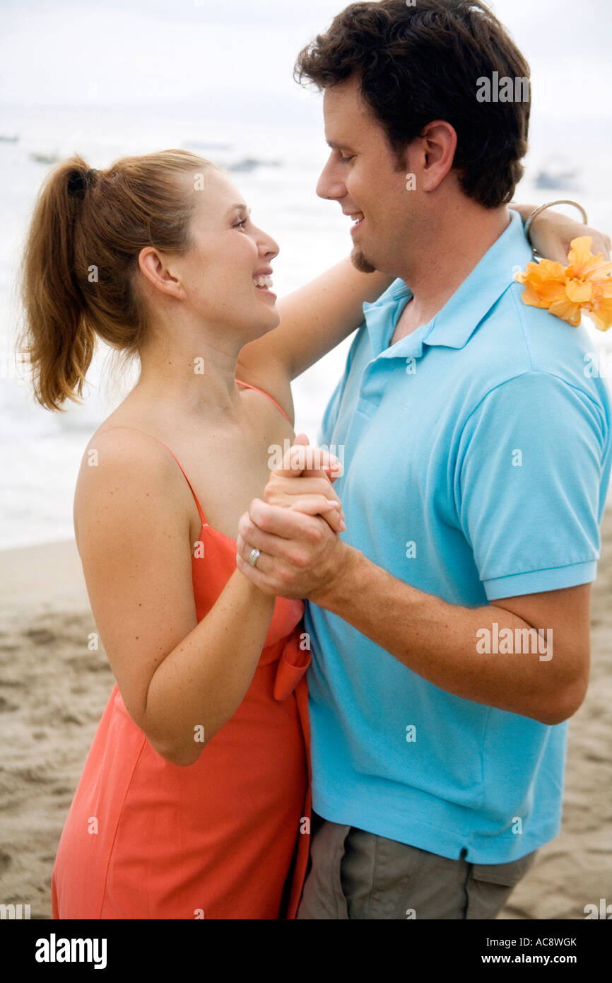Mid adult man and a young woman looking at each other and smiling on ...