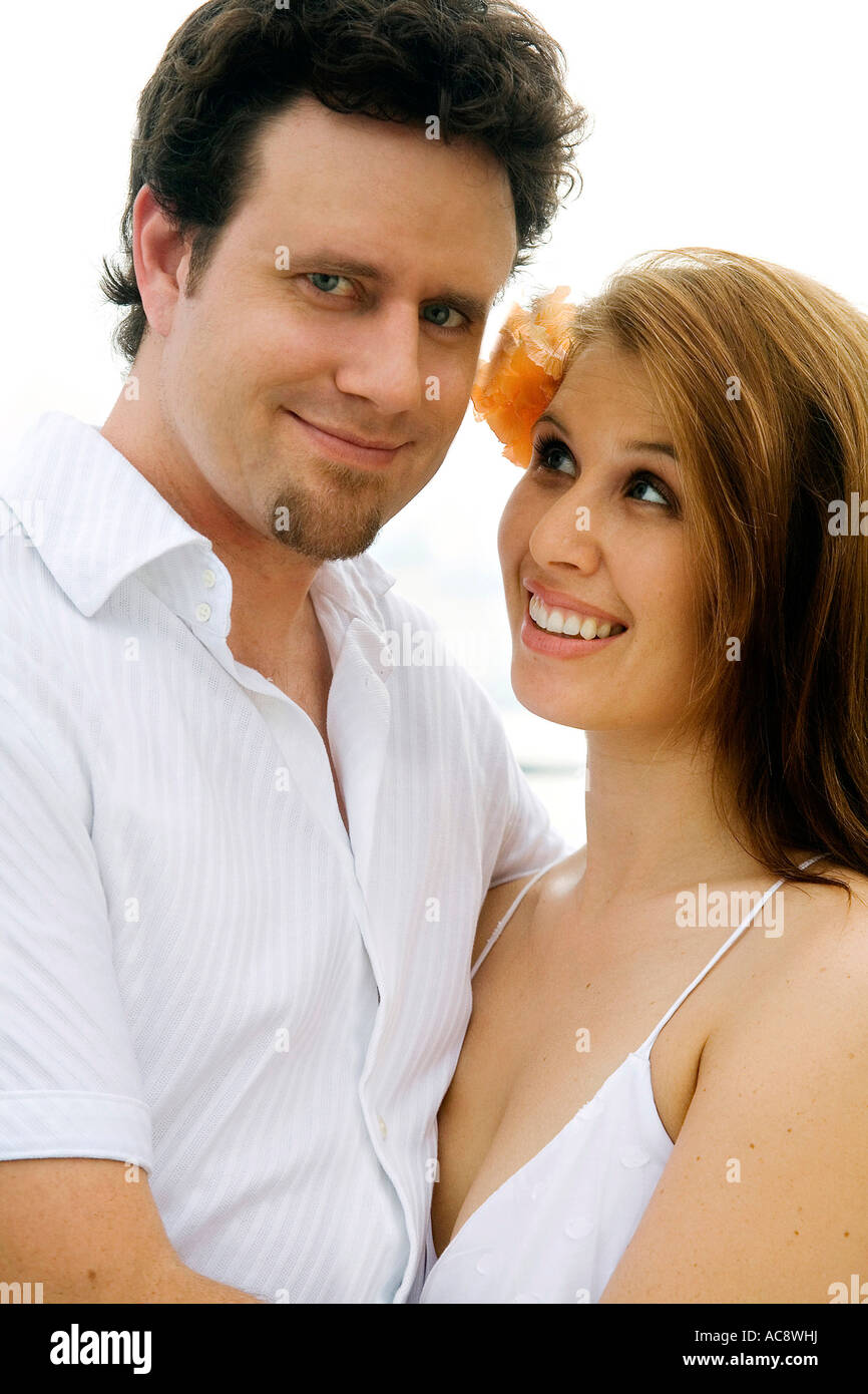 Portrait of a mid adult man embracing a young woman Stock Photo - Alamy