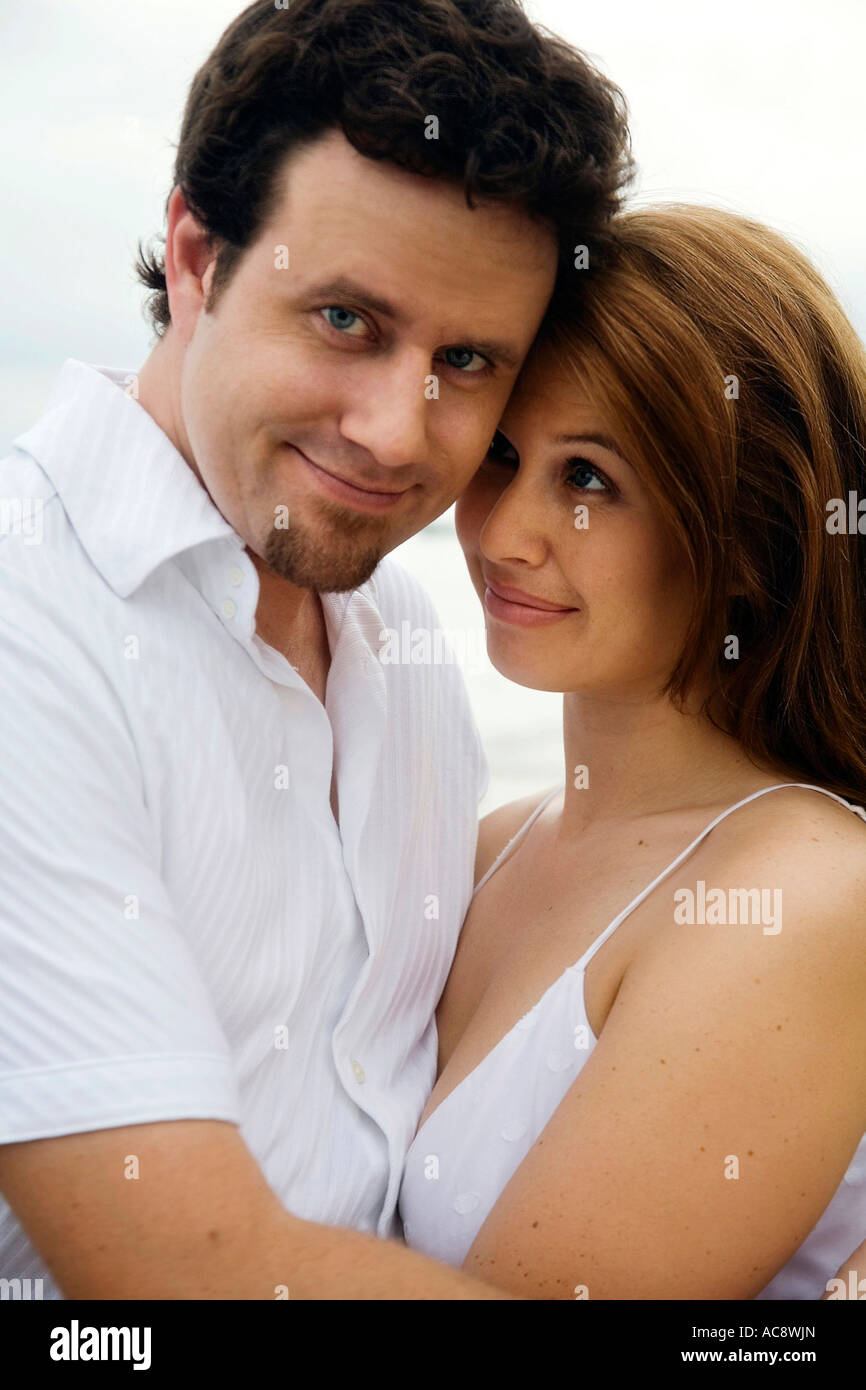 Portrait of a mid adult man embracing a young woman Stock Photo - Alamy