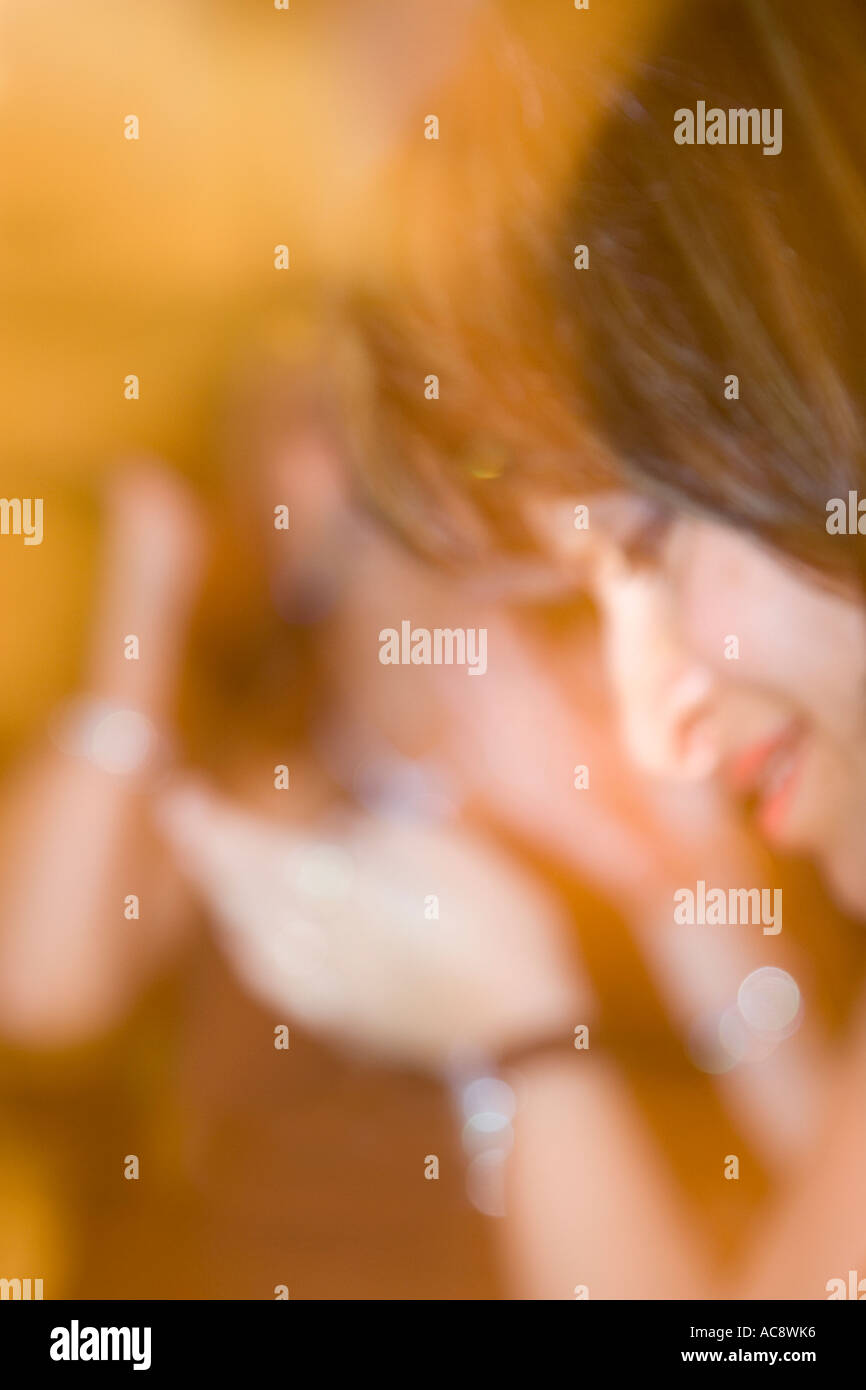 Portrait of Asian Woman Dancing at Party UK Stock Photo