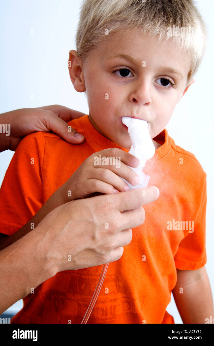 Woman helping boy with breathing machine Stock Photo Alamy