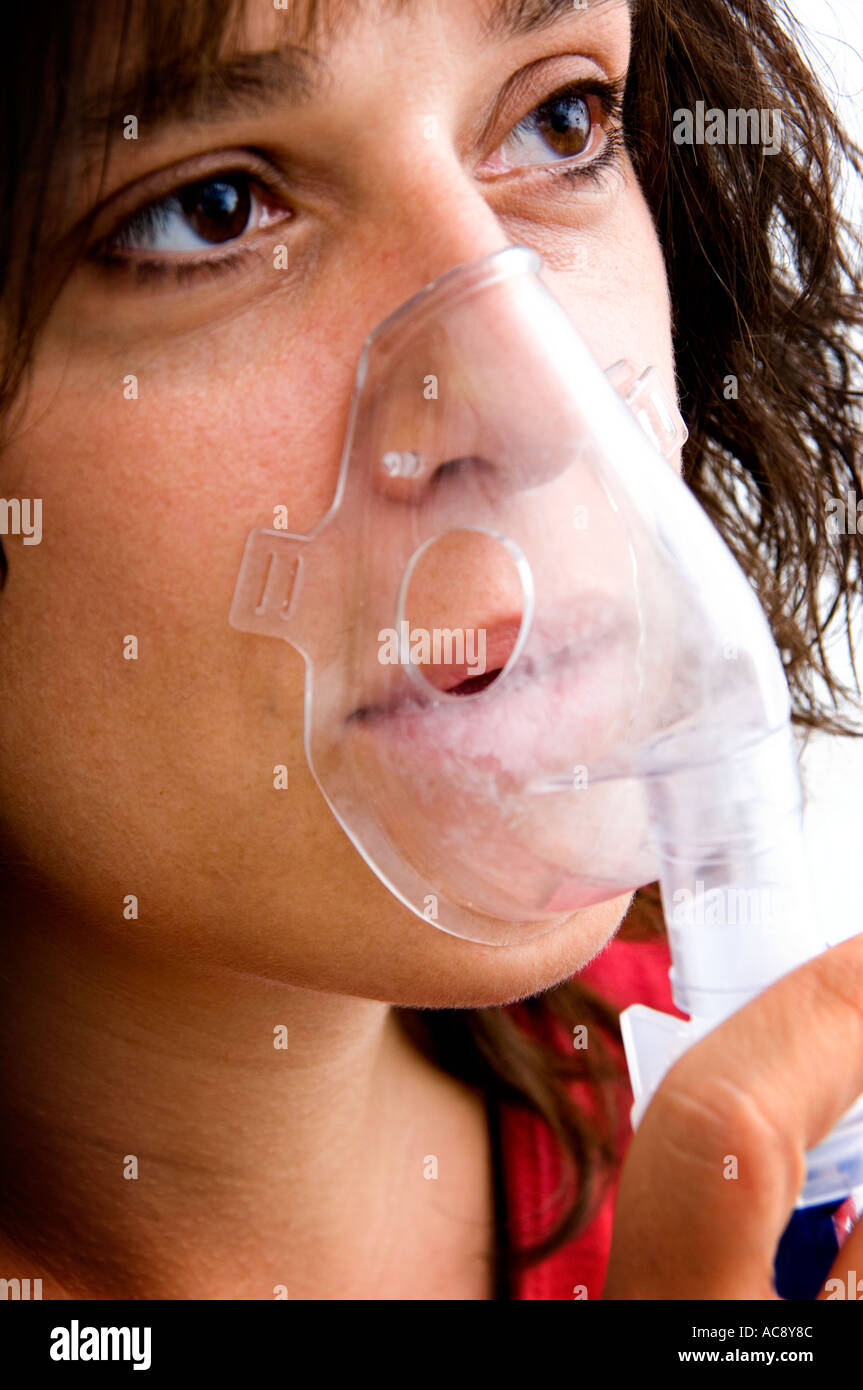 Woman using breathing machine Stock Photo