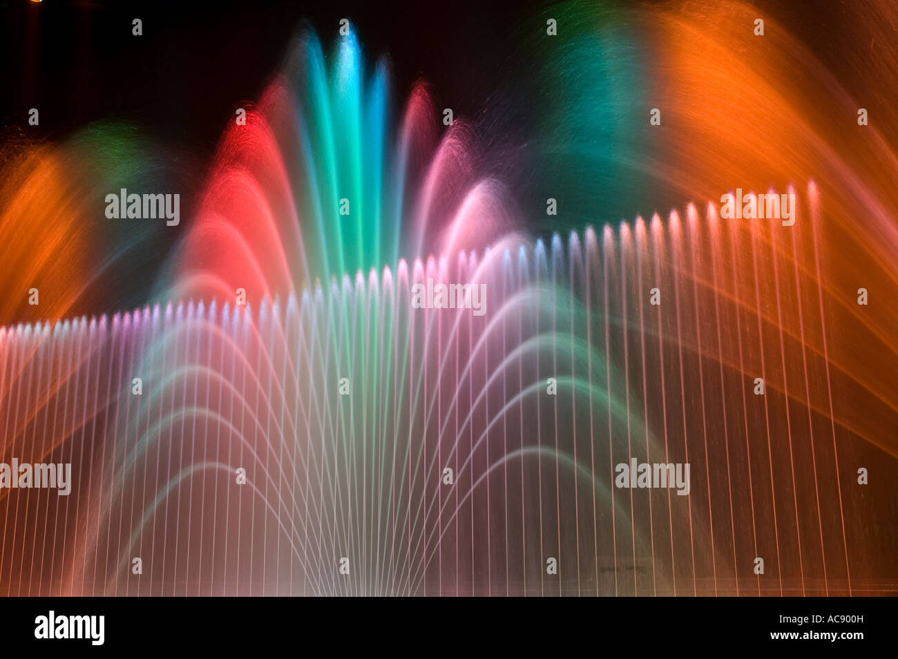 Computer controlled and synchronized water fountains are illuminated by
