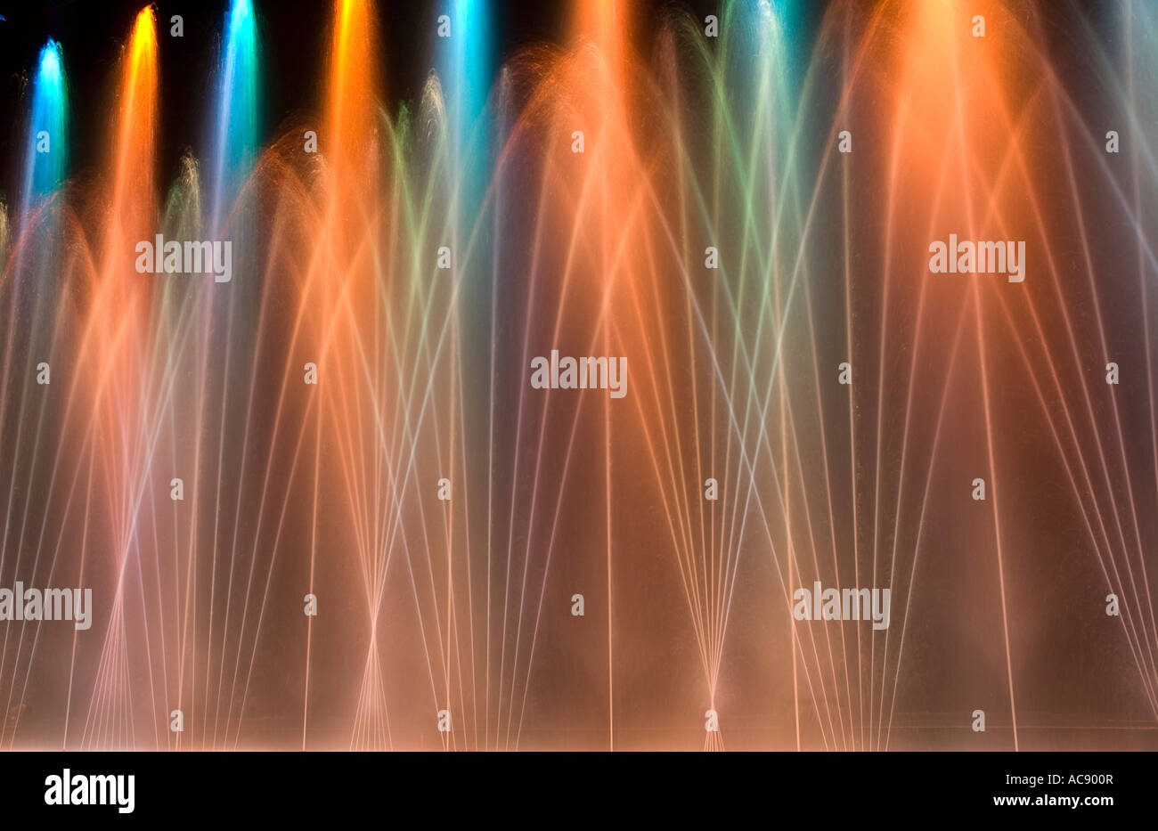 Computer controlled and synchronized water fountains are illuminated by