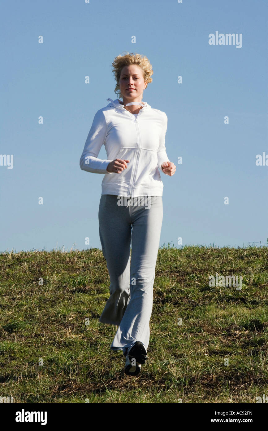 Mid adult woman running Stock Photo - Alamy