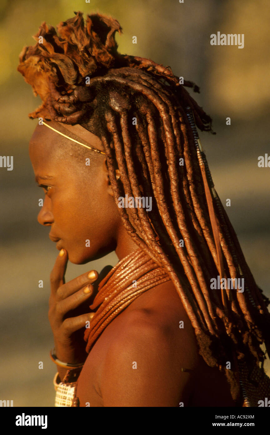 Himba maiden with ochre and blood used to groom hair Stock Photo