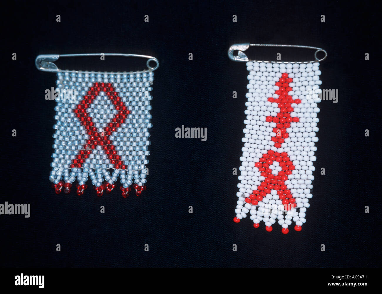 Beadwork brooches with the Aids and Tuberculosis emblem for sale at a