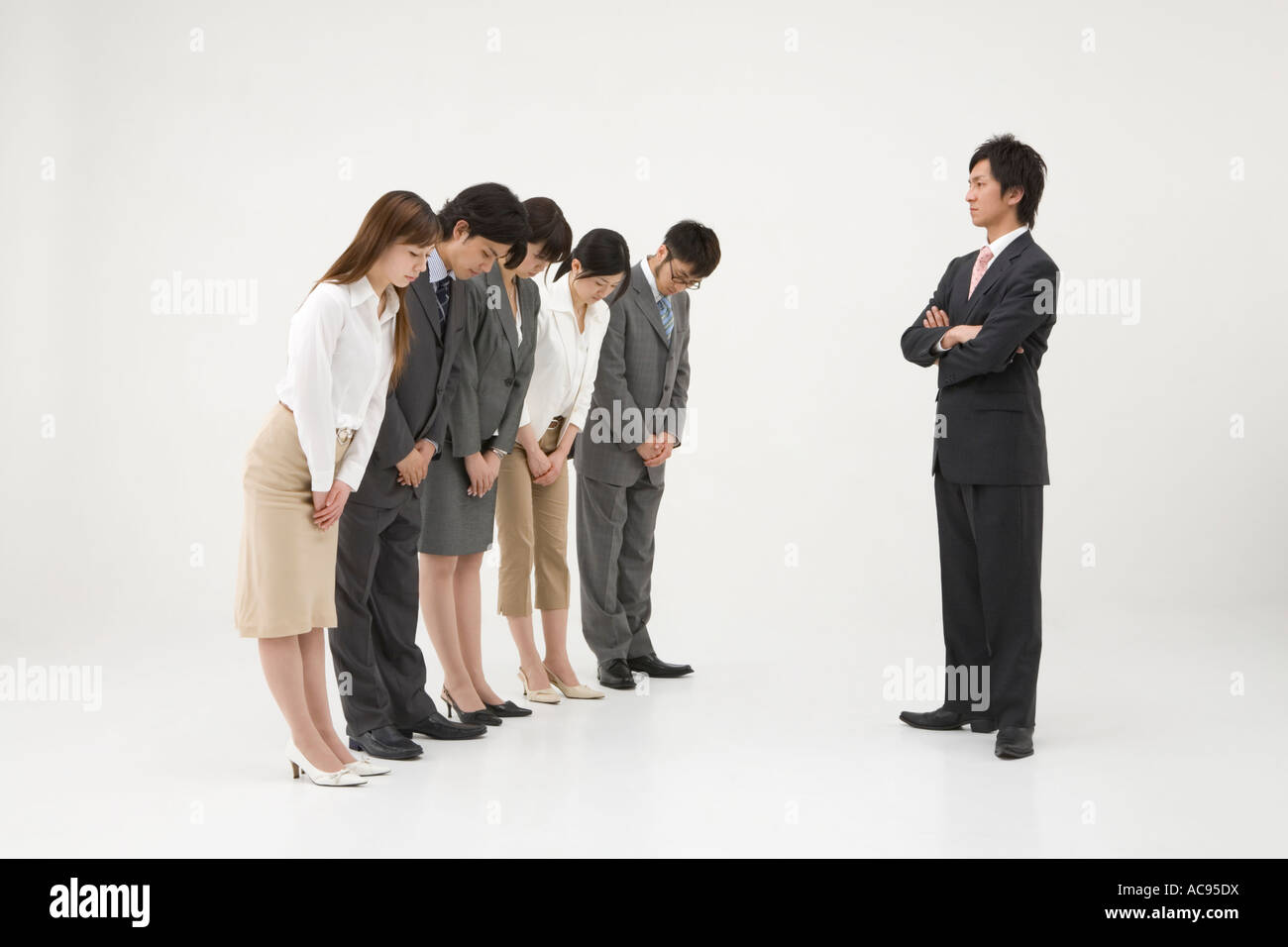 Business people bowing to businessman Stock Photo