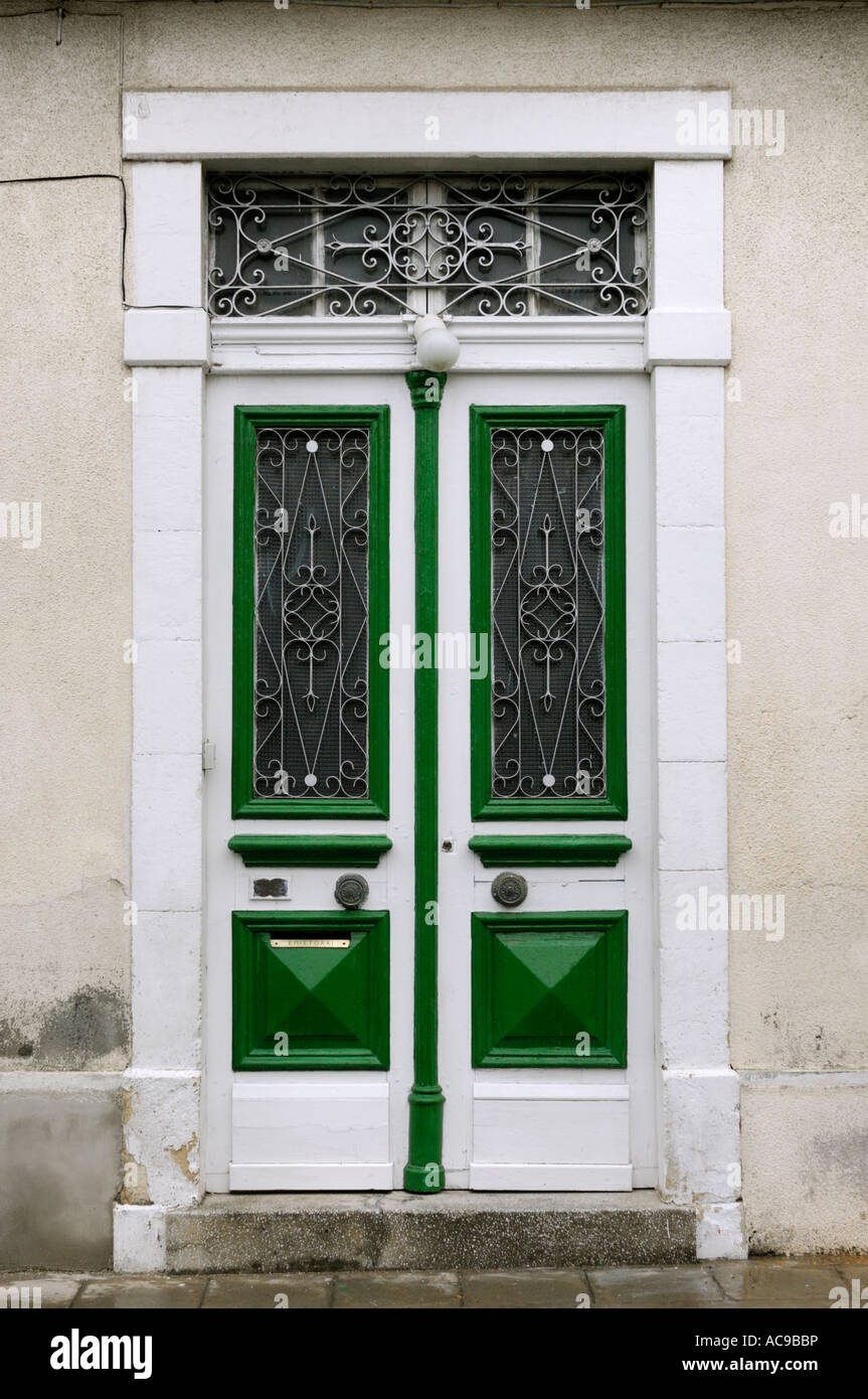 Old paneled white double door with decorative ironwork texture Stock Photo