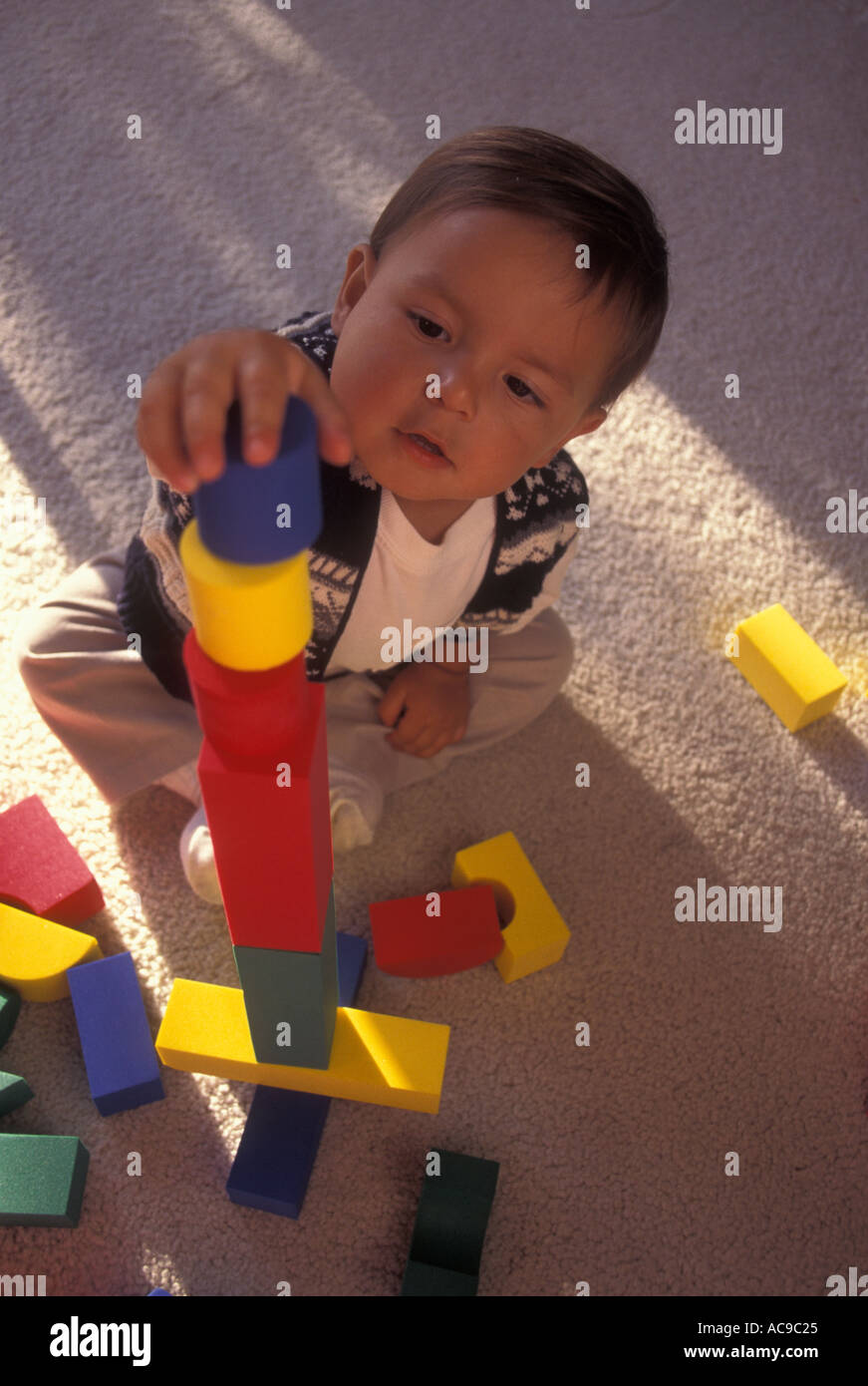Toddler boy playing and working hard on success with balance balancing colorful blocks  POV MR ©Myrleen Pearson Stock Photo