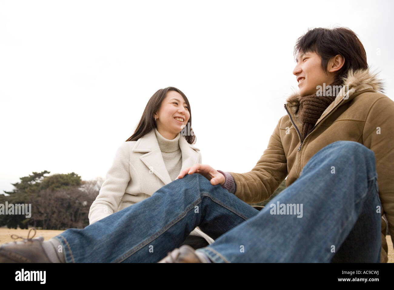 Woman sitting on ground hi-res stock photography and images - Alamy