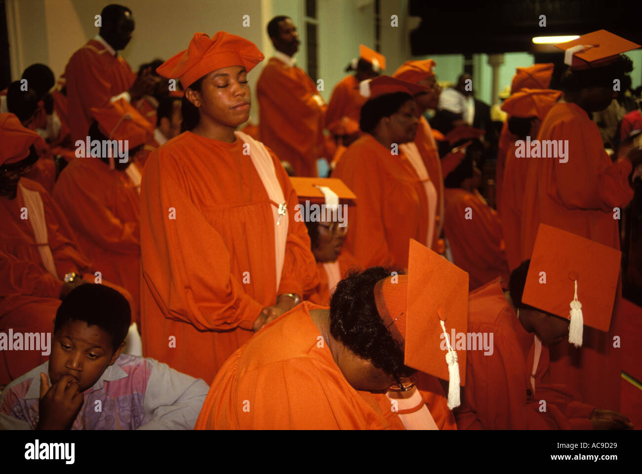 Congregation church service the choir in red praying the Calvary Church of God in Christ, London. Multiracial christianity 1990s UK.  HOMER SYKES Stock Photo