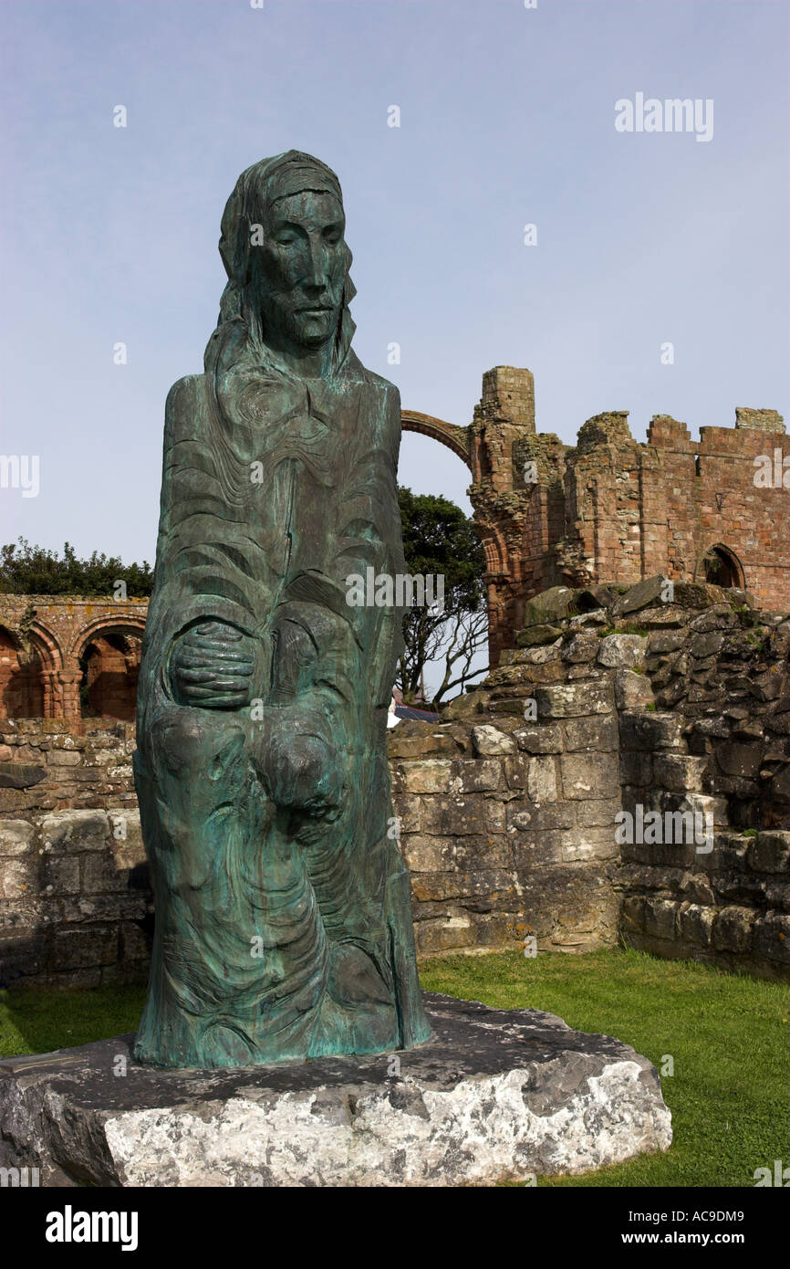 Statue of St Cuthbert standing in the grounds of Lindisfarne Benedictine Priory, Holy Island,  Lindisfarne, Northumberland Stock Photo