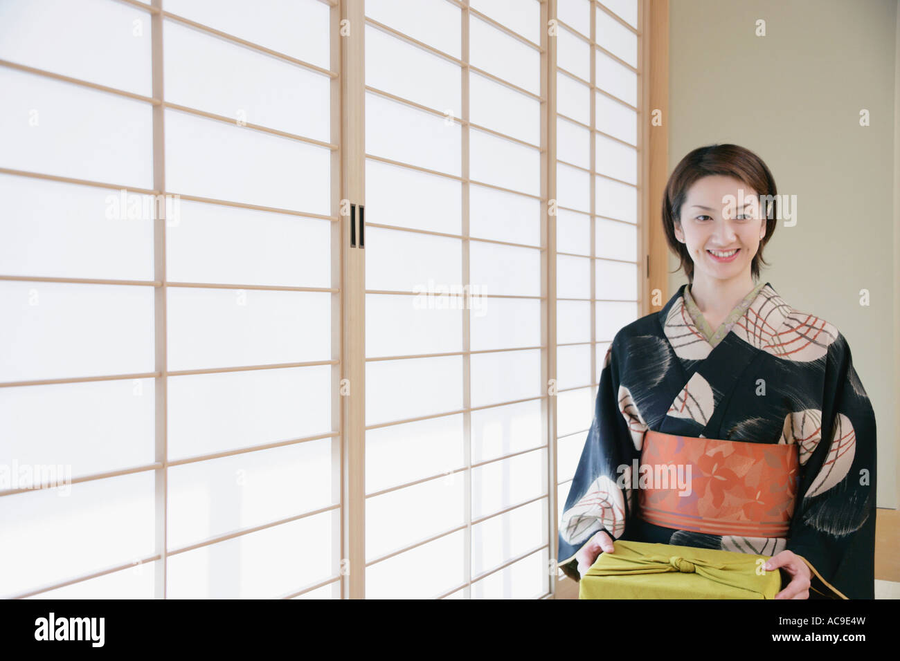 Young woman in kimono sitting on floor Stock Photo Alamy