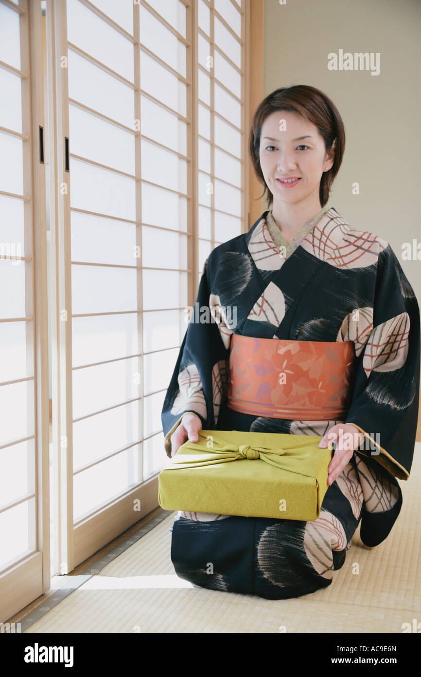 Young woman in kimono sitting on floor Stock Photo Alamy