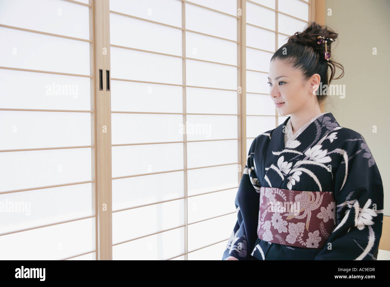 Young woman in kimono sitting on floor Stock Photo Alamy