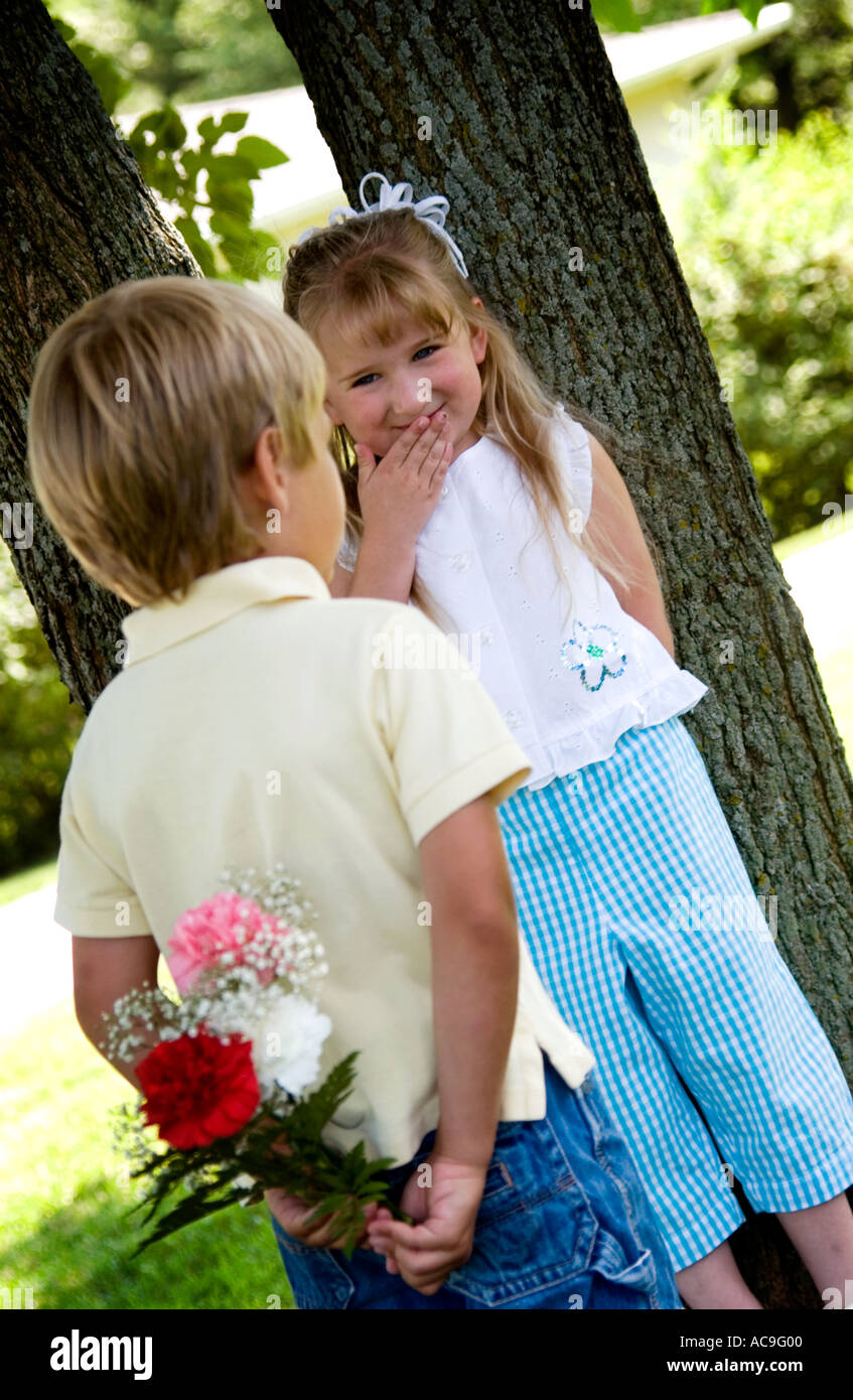 Boy giving girl flowers Stock Photo Alamy