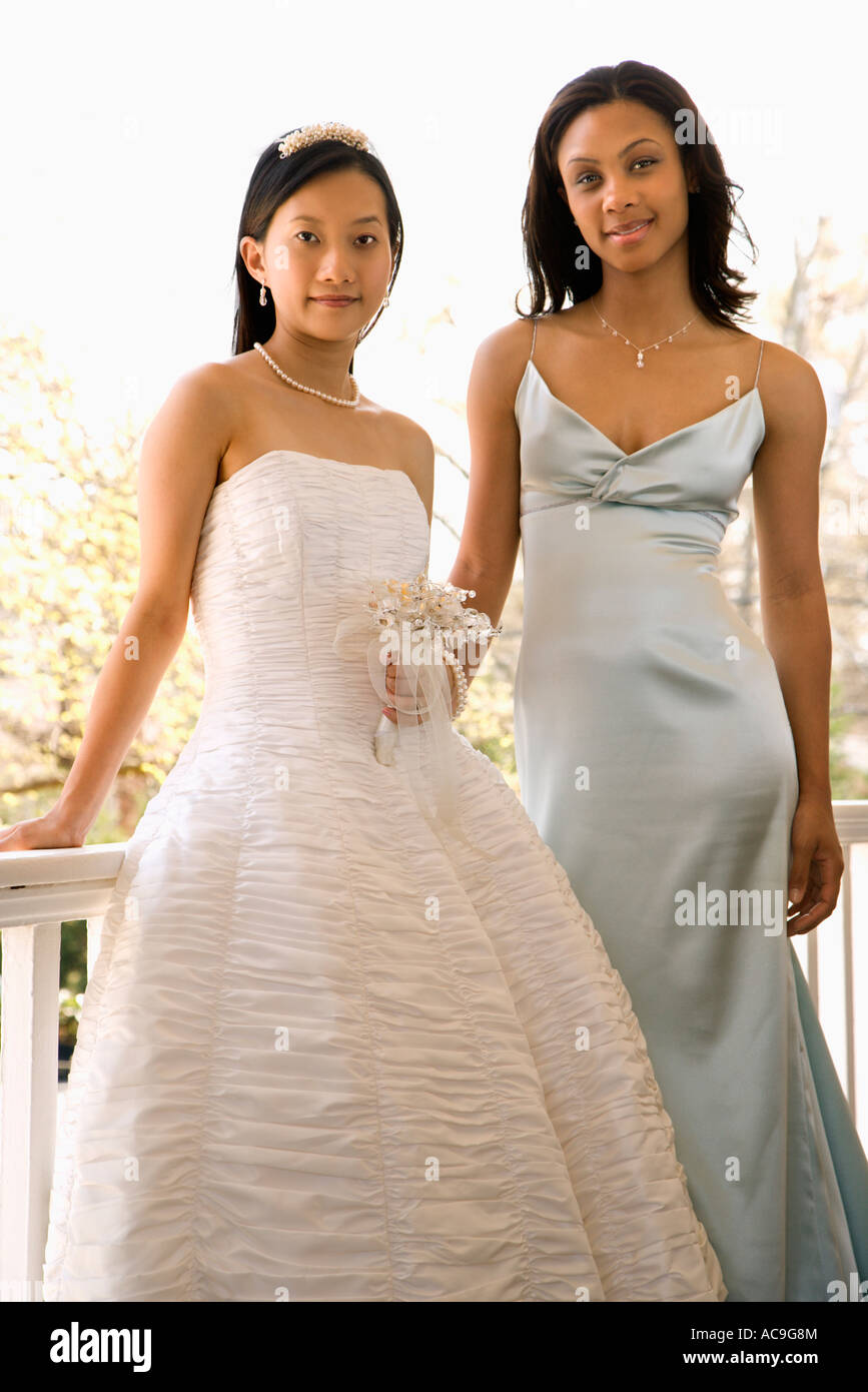 A Portrait Of A African American Maid Of Honor And Asian Bride