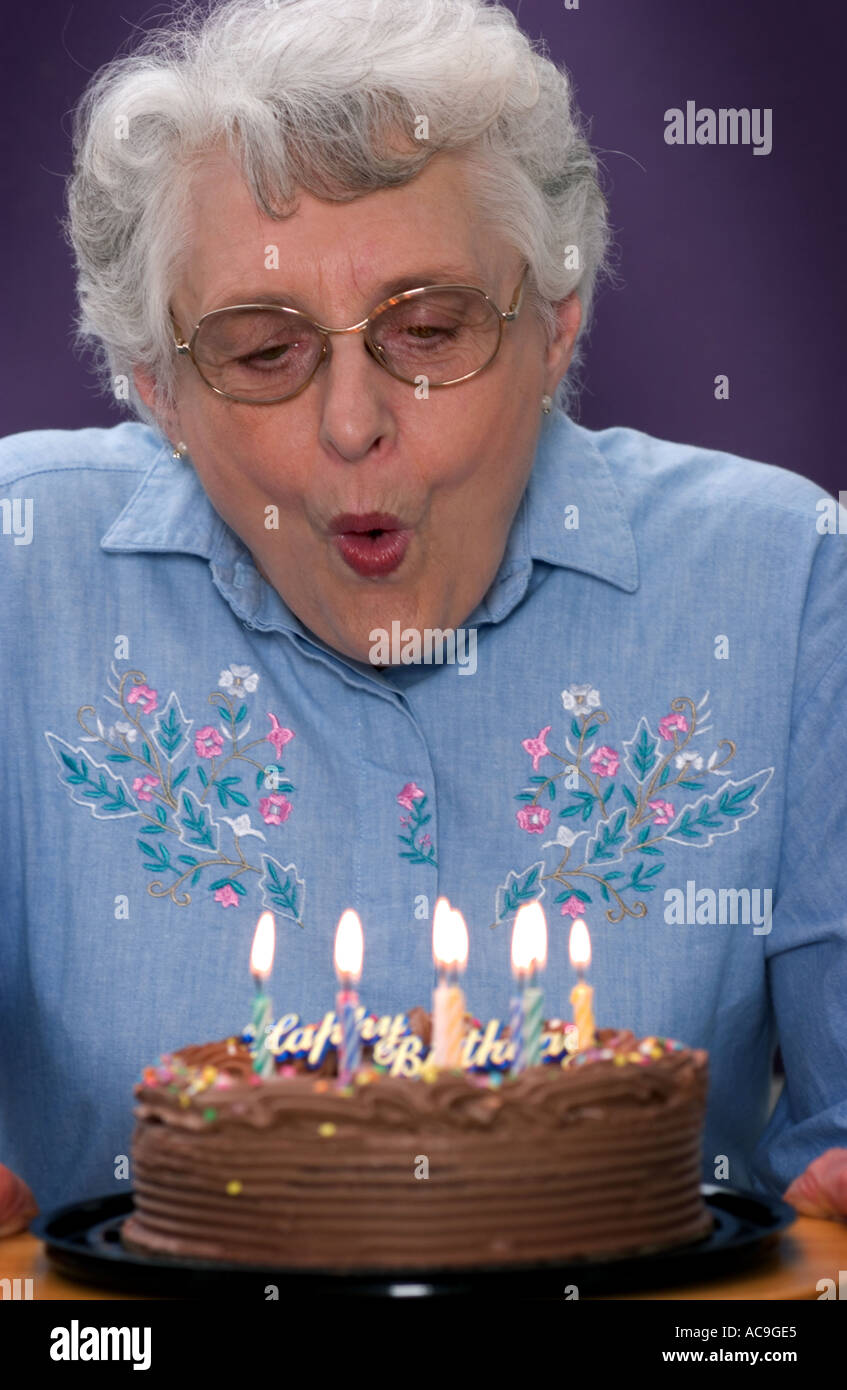 Senior woman with birthday cake Stock Photo