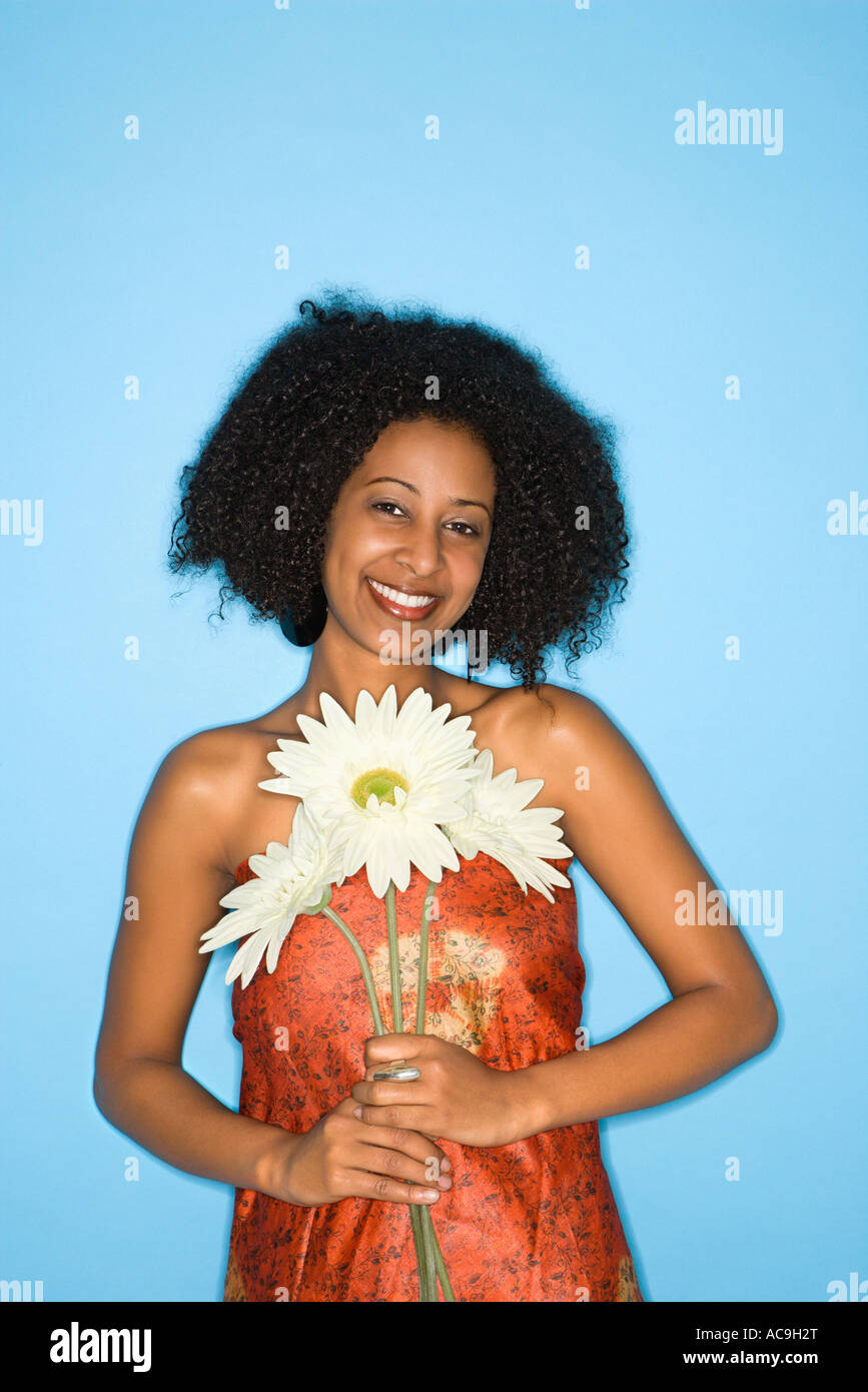 African American woman holding oversized fake flowers Stock Photo Alamy