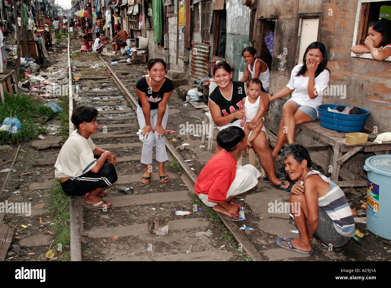 Family group on the tracks in Blumentritt, Manila, Philippines Stock