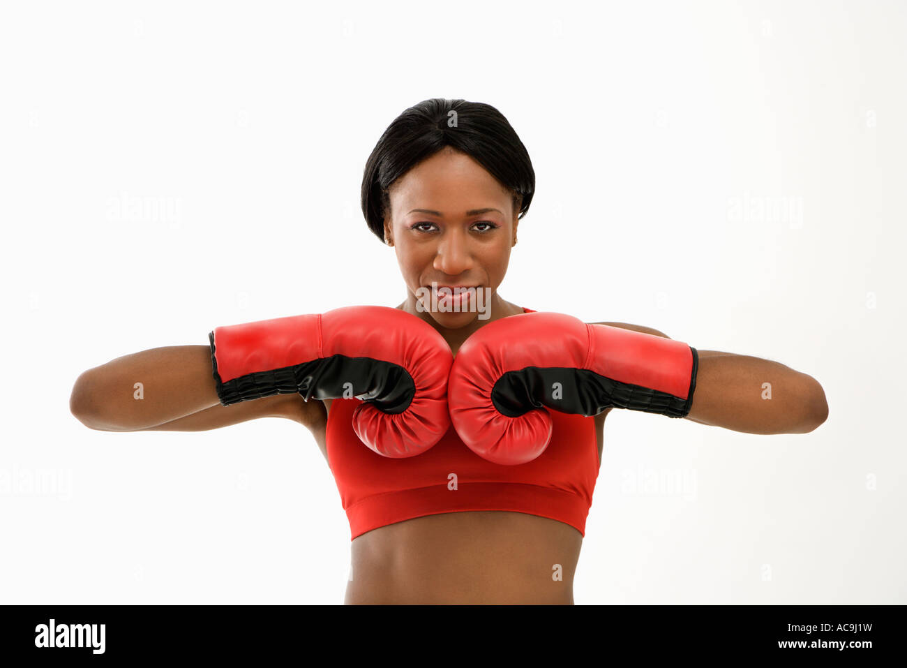 African American young adult woman wearing boxing goves with fists together Stock Photo