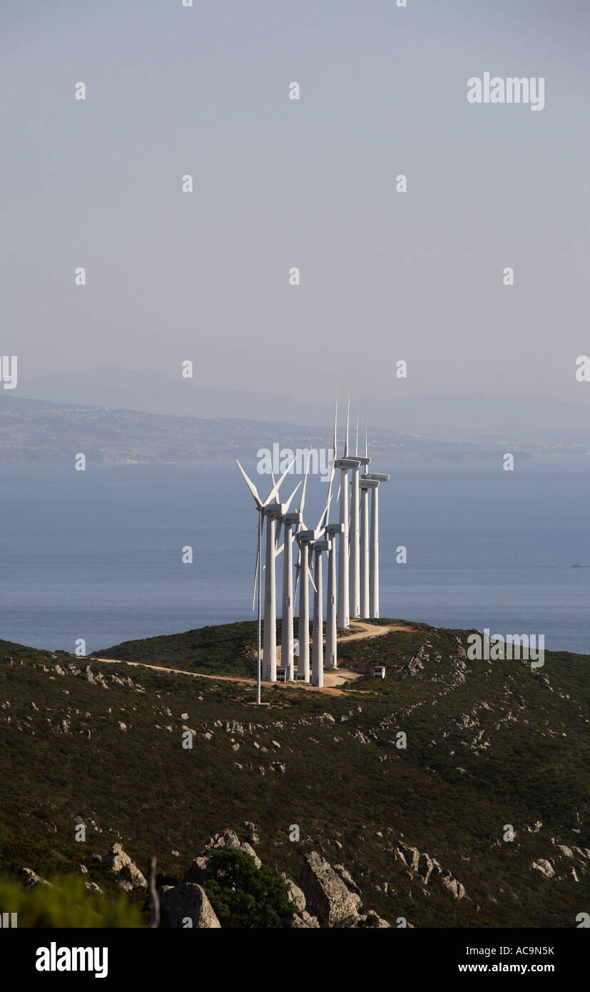 a line of windturbines in a coastal location with sun and clear sky Stock Photo