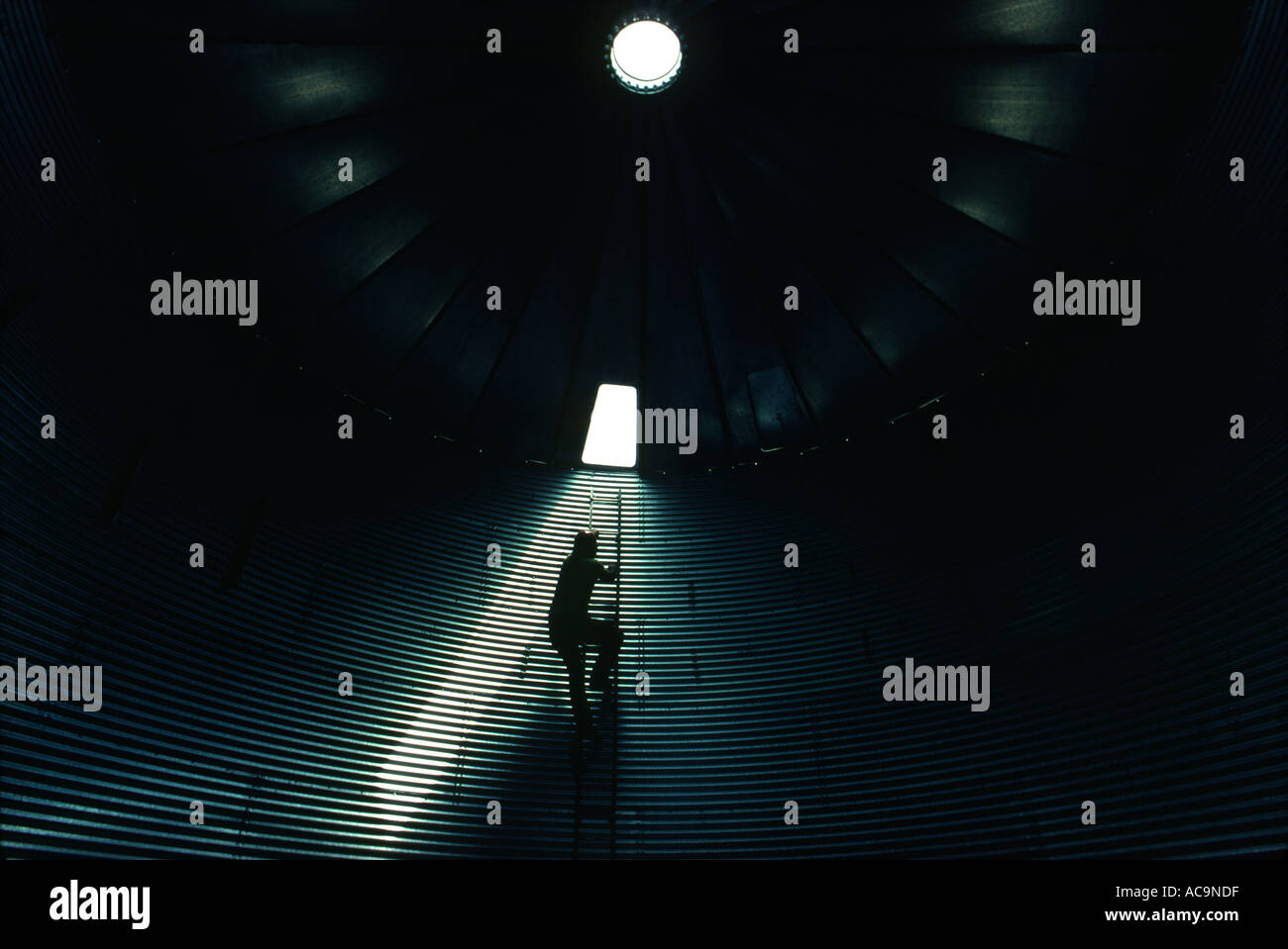 A man checks out the inside of a grain silo in Oklahoma Stock Photo - Alamy