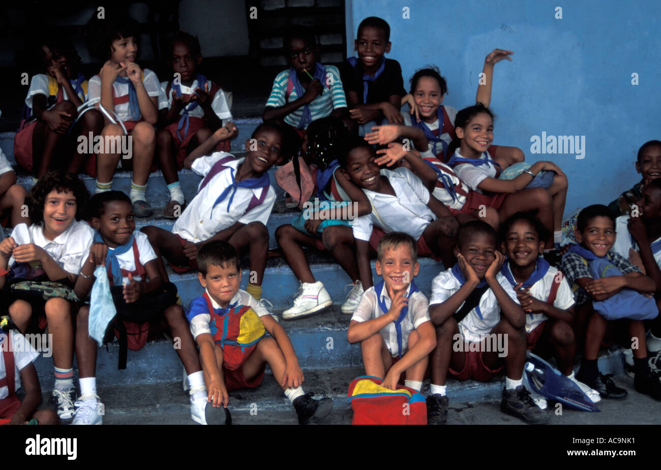Whooping Cuban school children seated on steps, Matanzas, Cuba Stock Photo