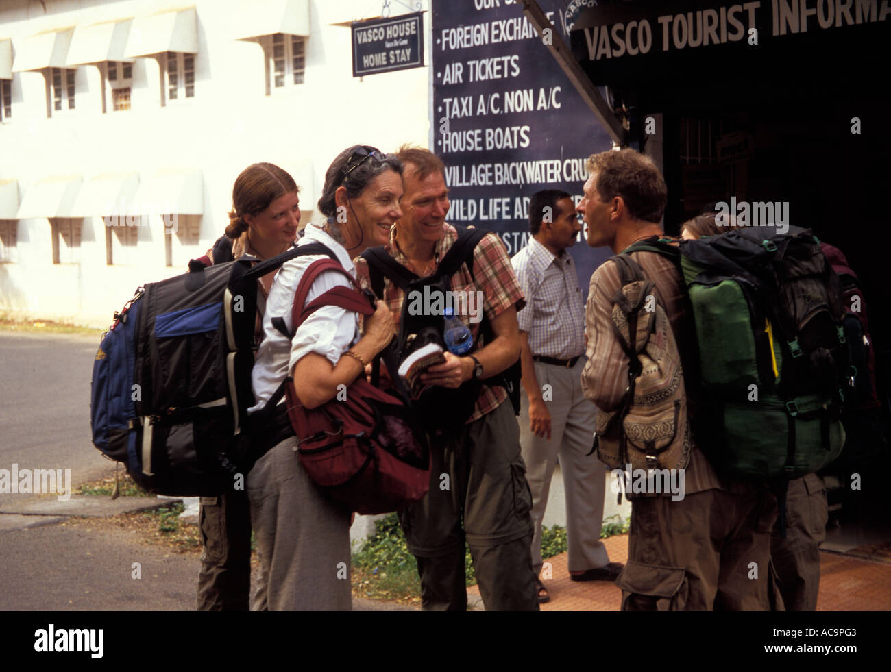 Western backpackers outside Tourist Information Office, Fort Kochi, (Cochin), Kerala, India