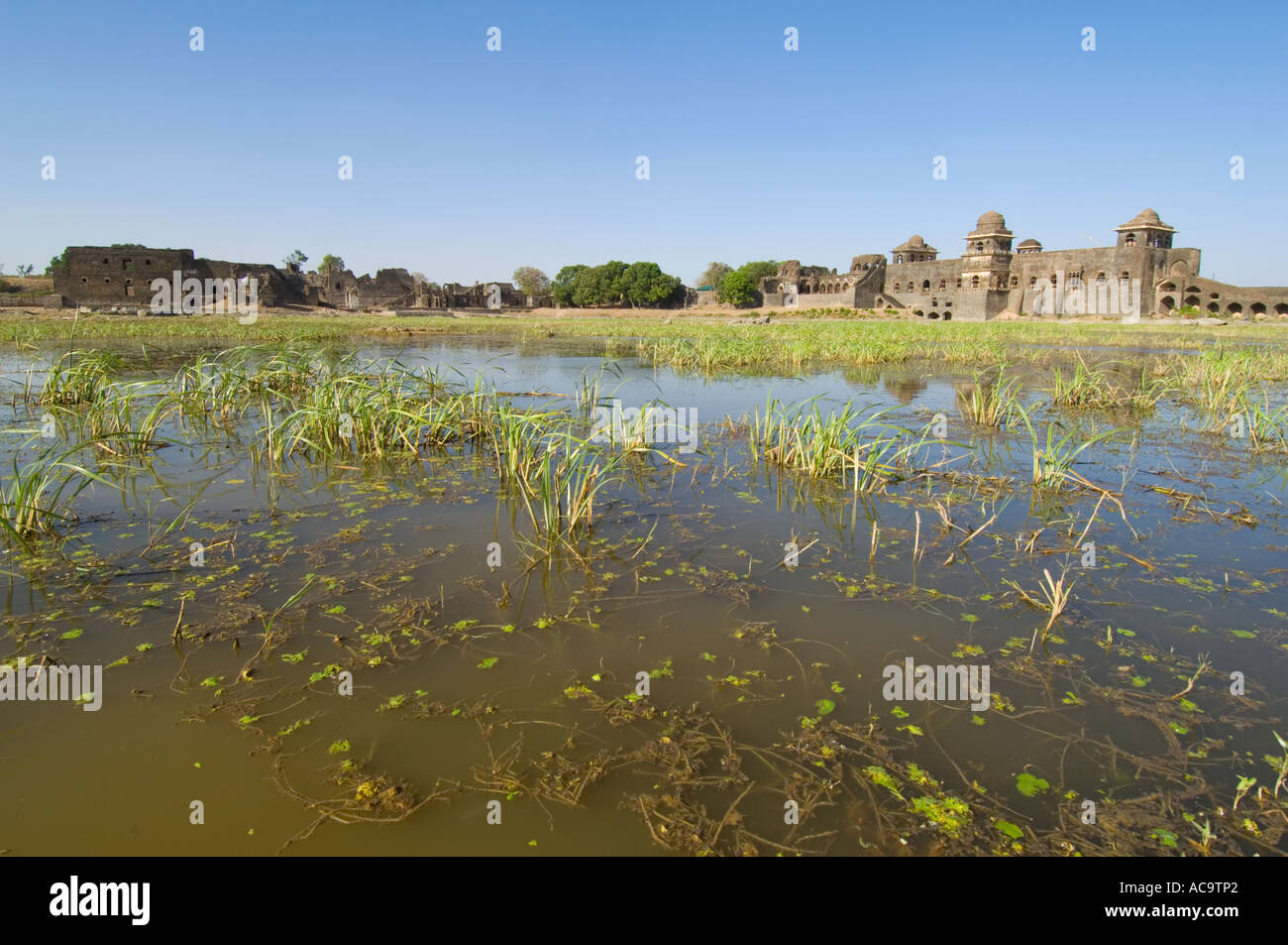 A wide angle view across one of the man-made lakes (Kapur Talao) of the Royal Enclave and the Ship's Palace (Jahaz Mahal). Stock Photo