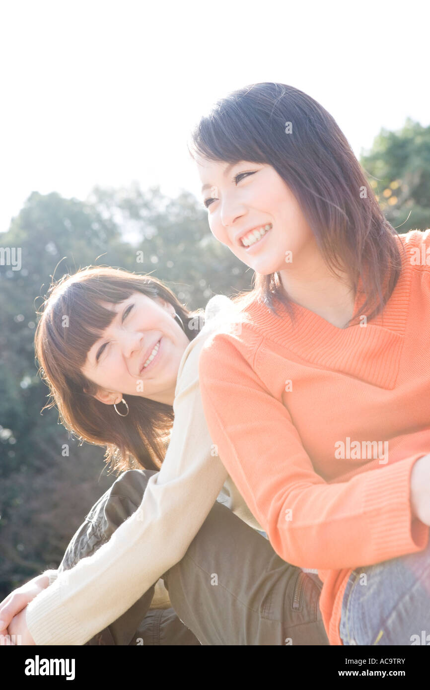 Two women in park sitting hi-res stock photography and images - Alamy