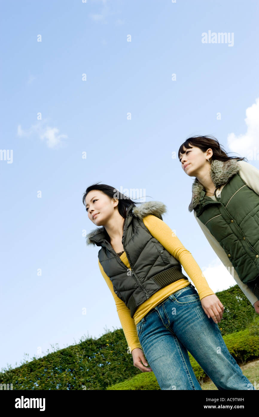 Two young women walking Stock Photo - Alamy