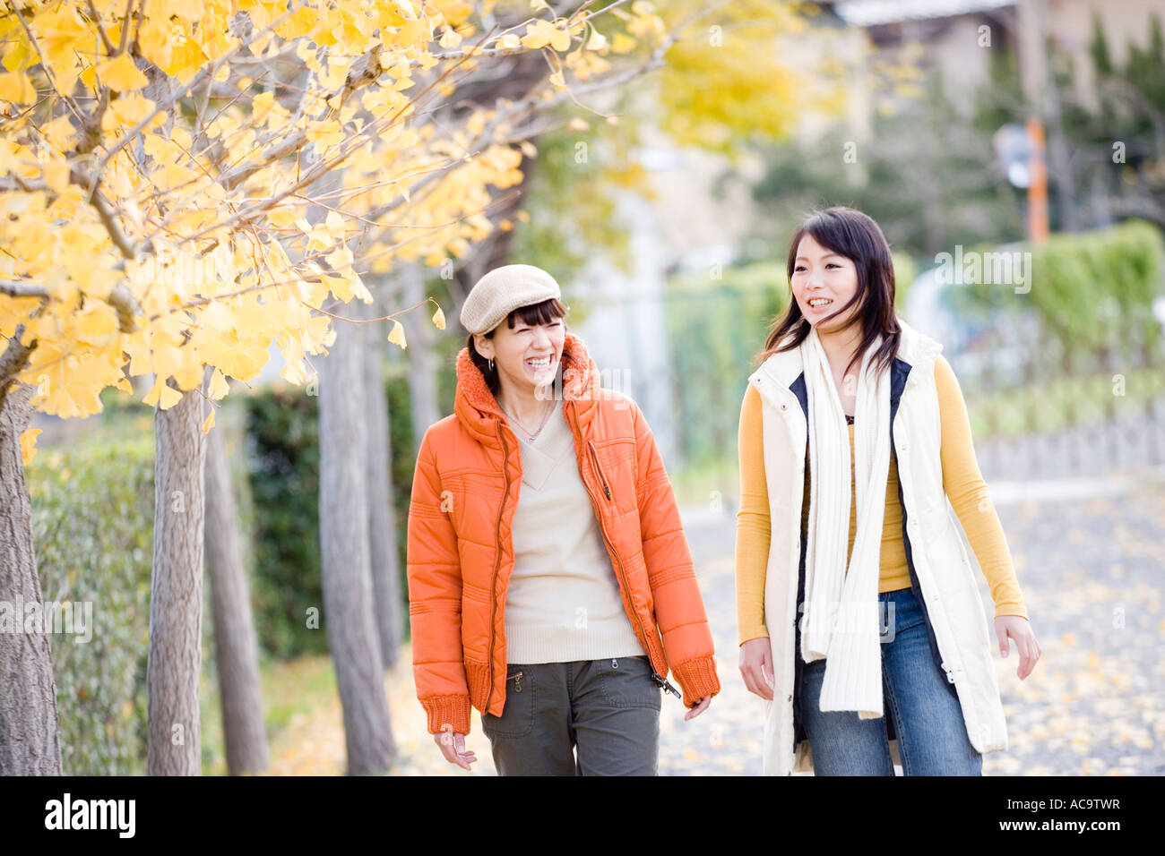 Two young women walking Stock Photo - Alamy