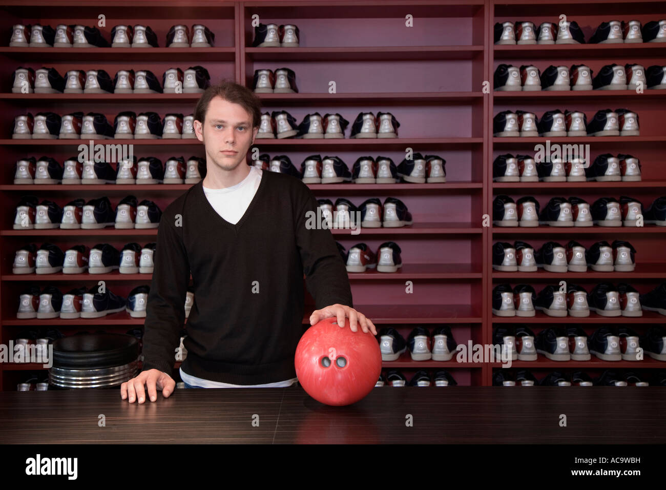 Bowling attendant at the reception in a bowling centre Stock Photo Alamy