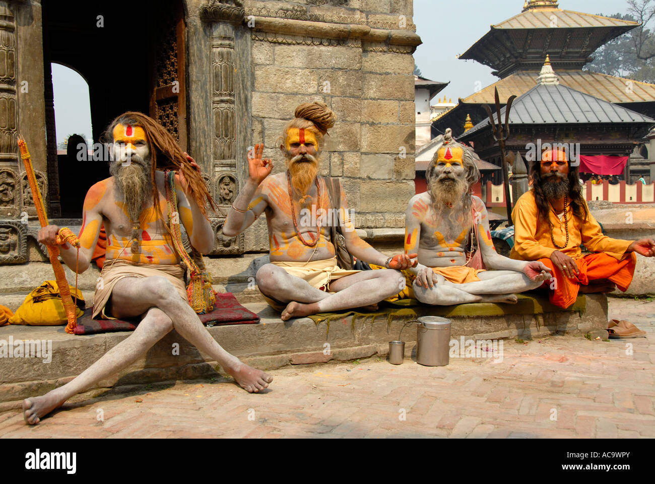 Four holy men sadhus bless colourfully painted Pashupatinath Kathmandu Nepal Stock Photo