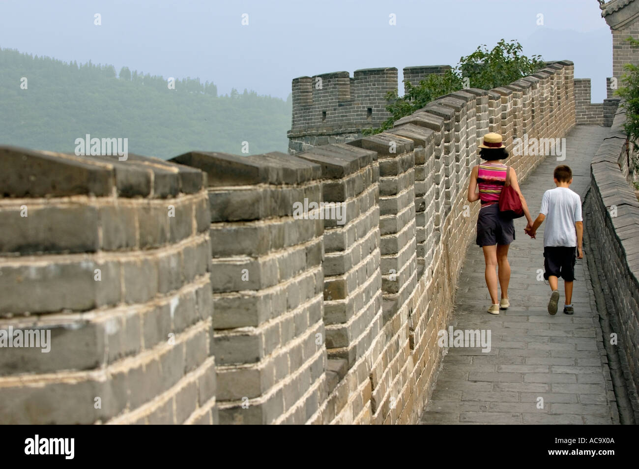 Woman And Her Son Walking On The Great Wall of China At Juyongguan Gate Near Badaling, China Stock Photo